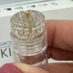 small clear plastic device with 20 mini gold needles - Skin tox
