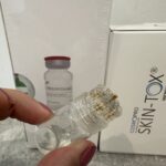 small clear plastic device with 20 mini gold needles - Skin tox