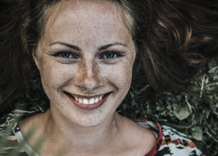 Woman with freckled face smiling